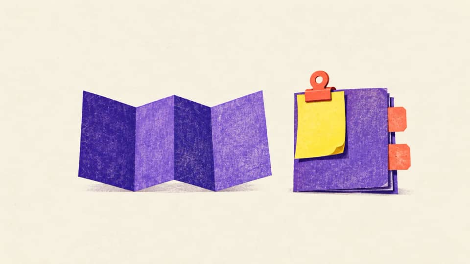 A violet folded fan sits apart from a yellow draft slip clipped to a review folio with two open correction tabs.