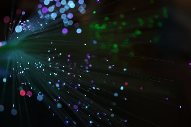 Multicolored fiber optic strands fanning outward, representing the flow of traces, metrics, and logs through an OpenTelemetry collector pipeline